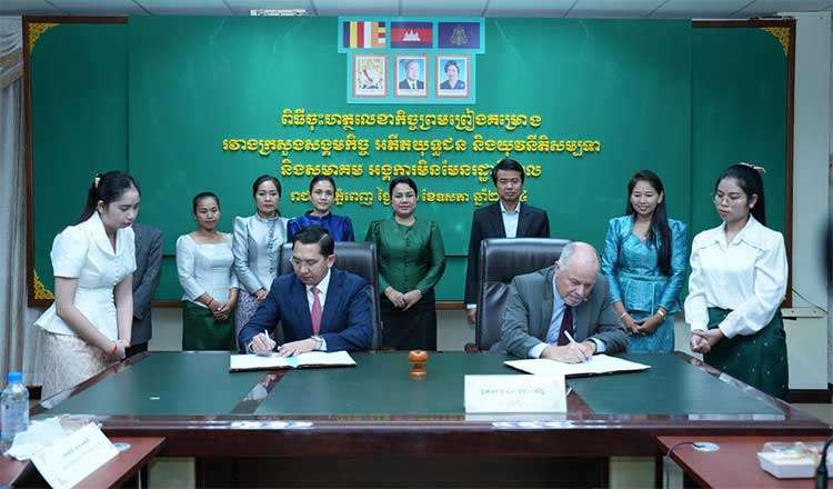 AIM Country Director Jim McMoran signs MOUs with the Cambodian Government.
