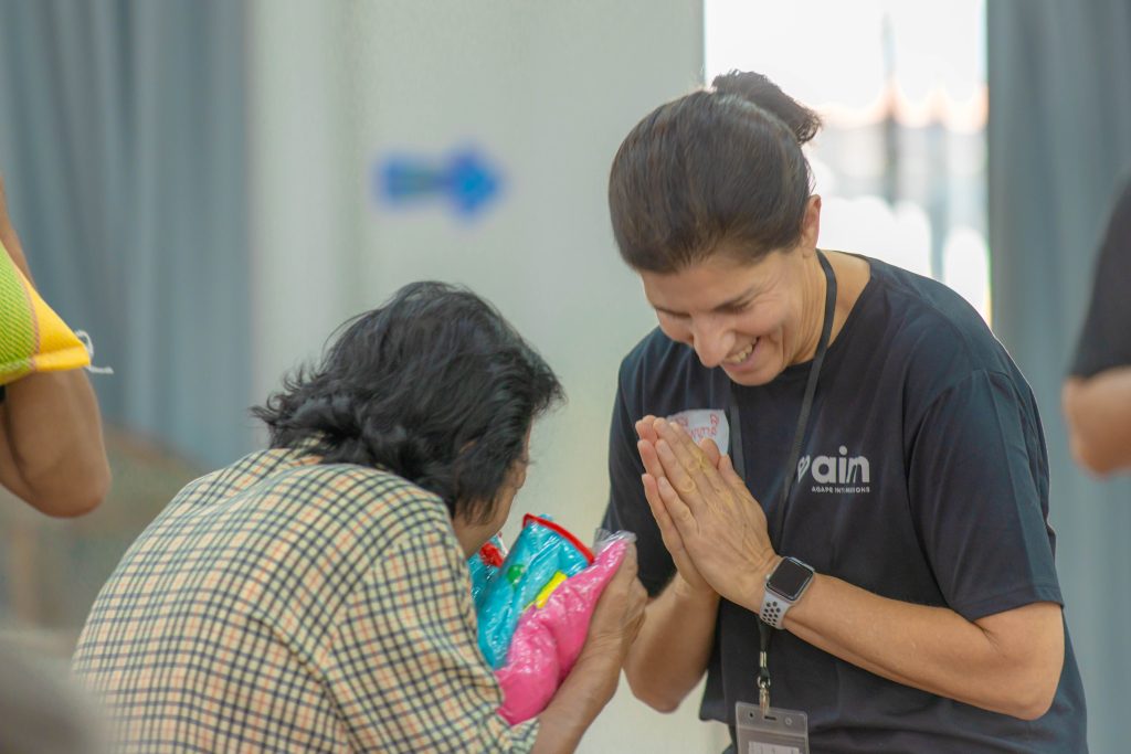 AIM Vision Trip Volunteer Greeting Cambodian Woman