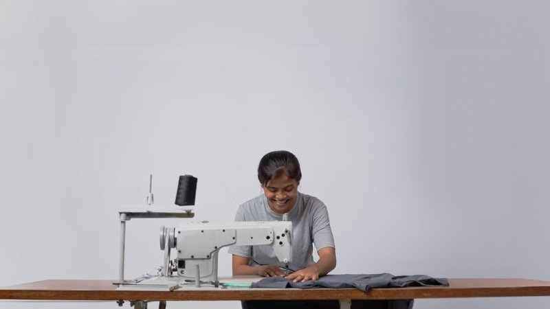 Survivor at work, hands building a future